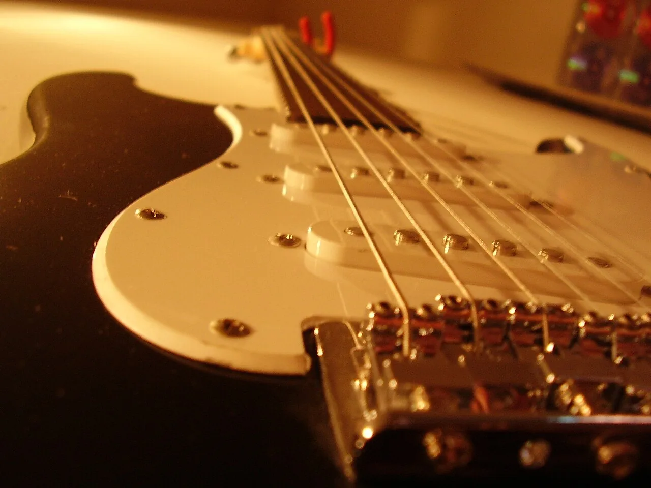 Electric guitar signal chain beginning at vibrating strings and magnetic pickups