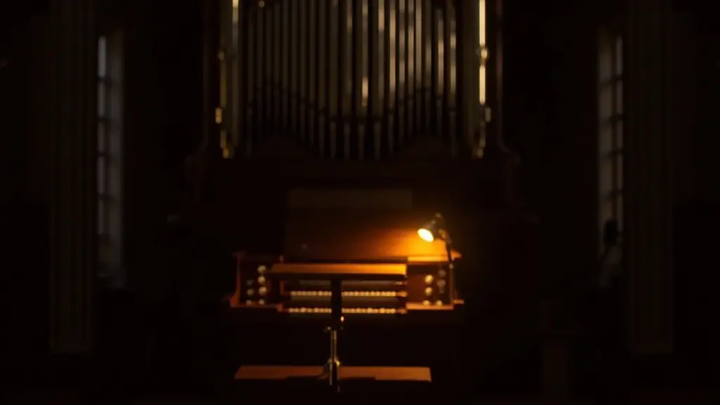 A quiet hall lit for a calm music recital on a pipe organ
